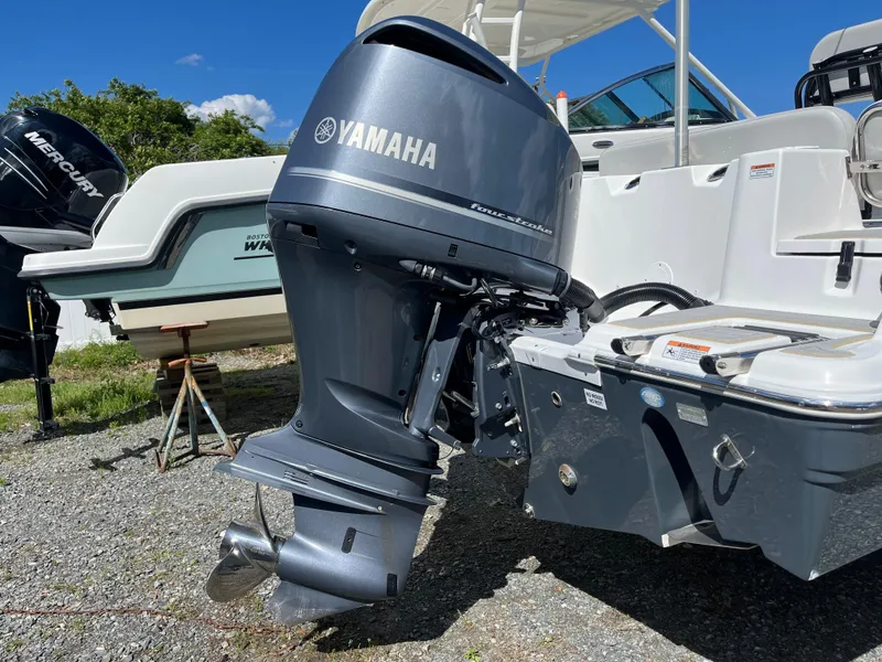 Slide: The Image of 2021 Sea Fox 248 Commander with Yamaha outboard motor, parked on gravel. - 23