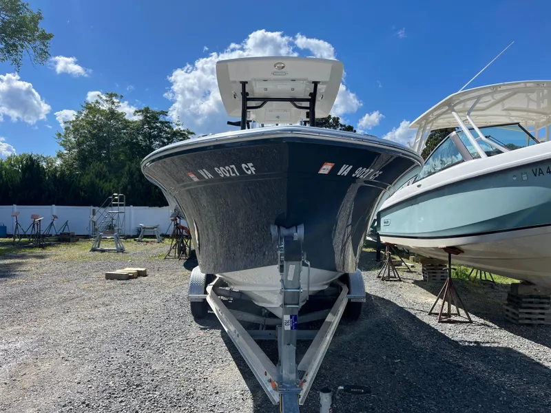 Slide: The Image of 2021 Sea Fox 248 Commander boat on trailer, parked outdoors under a clear blue sky. - 26