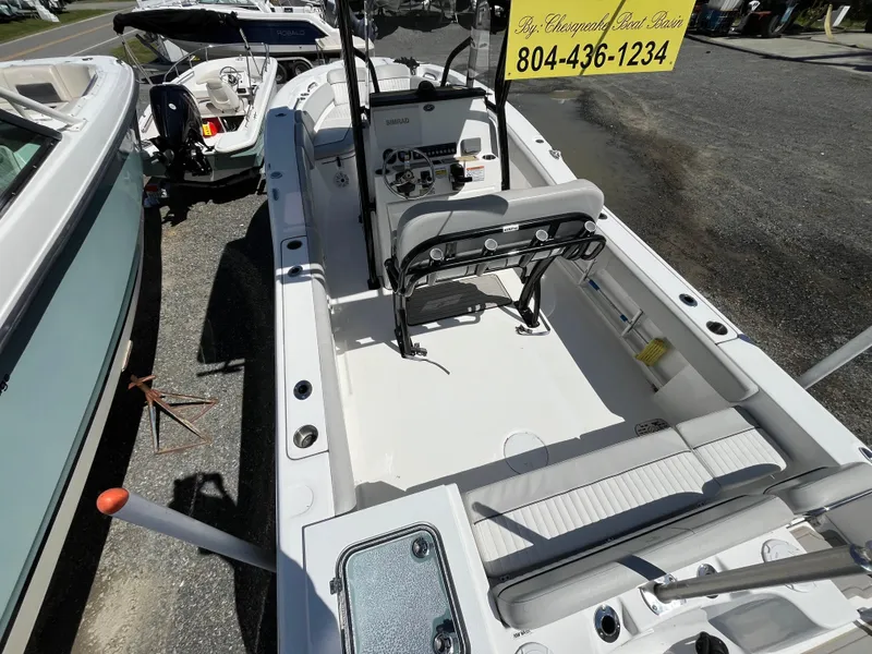 Slide: The Image of 2021 Sea Fox 248 Commander boat interior with seating and control panel, displayed outdoors. - 3