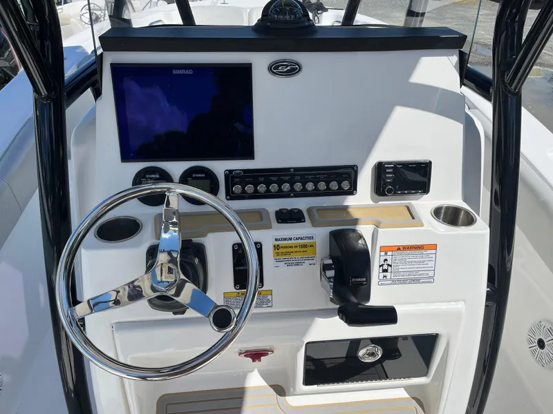 Slide: The Image of 2021 Sea Fox 248 Commander boat dashboard with steering wheel, controls, and display screen. - 4