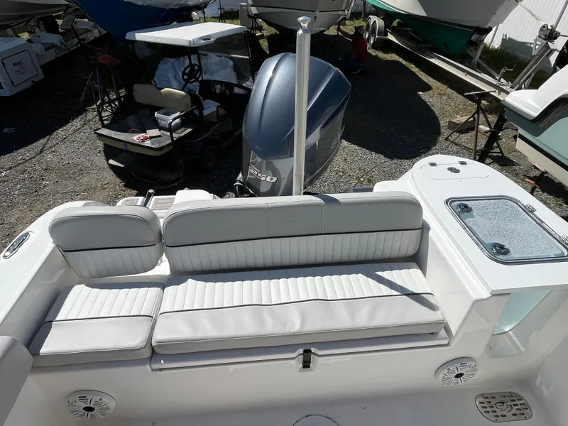 Slide: The Image of 2021 Sea Fox 248 Commander boat interior with cushioned seating and outboard motor. - 7