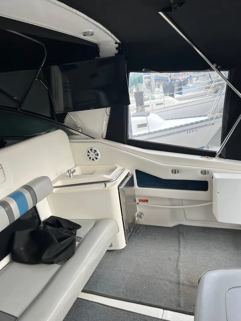 Slide: The Image of 1991 Sea Ray 350 Sundancer interior with seating, sink, and window view. - 11