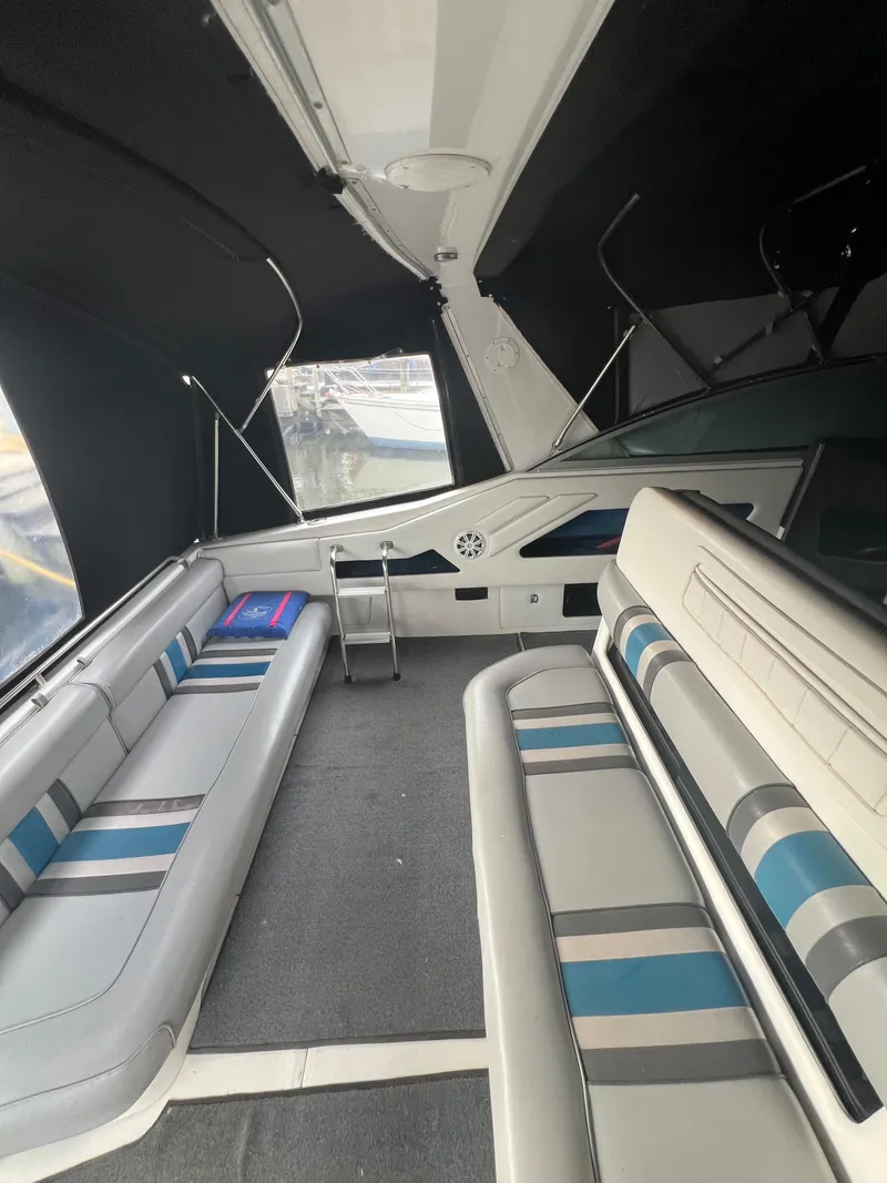 Slide: The Image of 1991 Sea Ray 350 Sundancer interior with cushioned seating and modern design. - 12