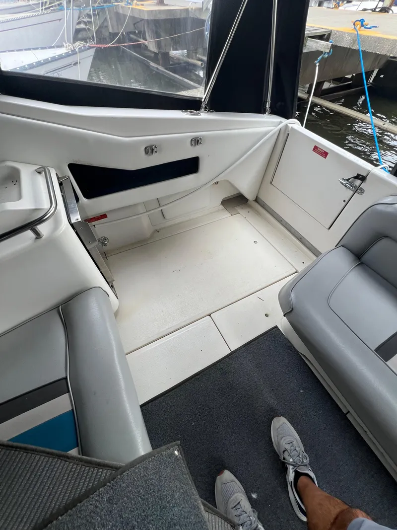 Slide: The Image of Interior view of a 1991 Sea Ray 350 Sundancer boat, featuring seating and deck area. - 18