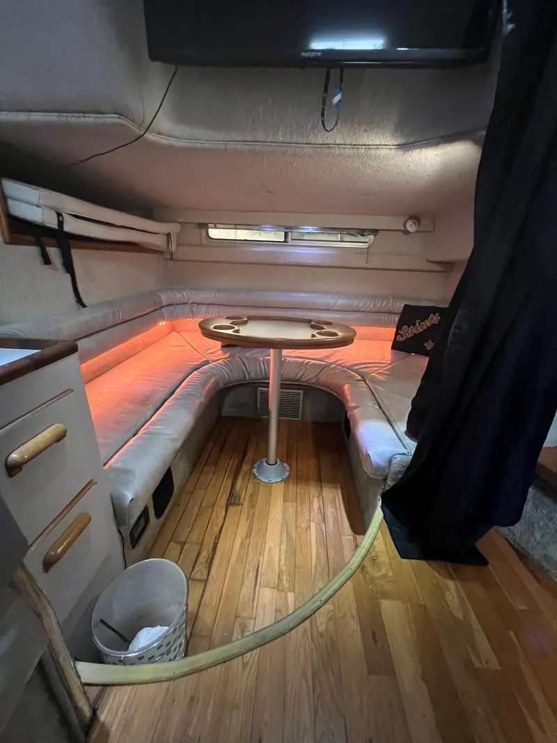 Slide: The Image of 1991 Sea Ray 350 Sundancer cabin interior with cozy seating and ambient lighting. - 22