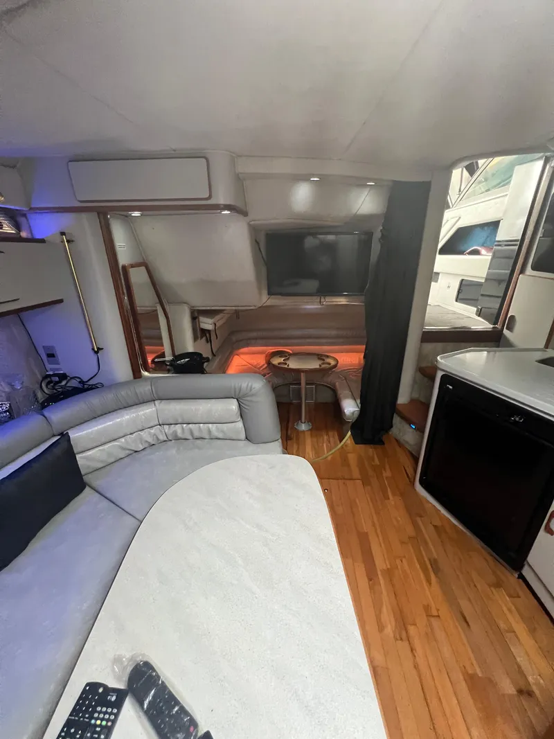 Slide: The Image of Interior of a 1991 Sea Ray 350 Sundancer yacht with modern amenities and wood flooring. - 23