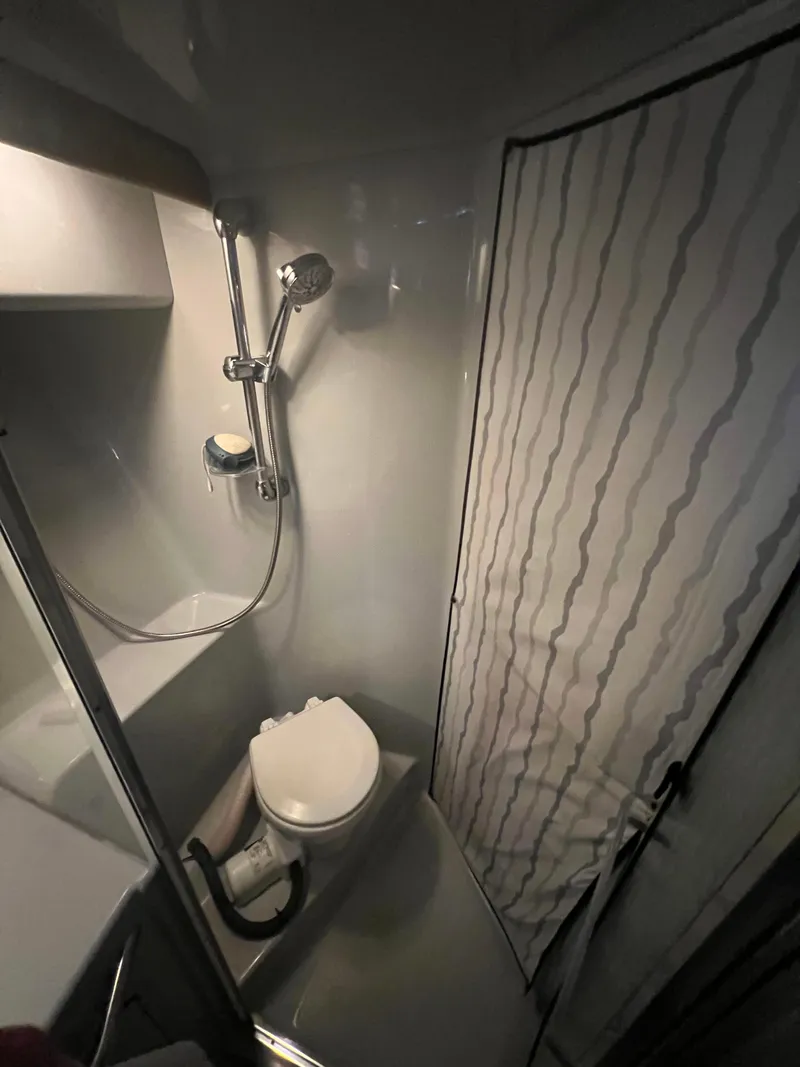 Slide: The Image of 1991 Sea Ray 350 Sundancer bathroom with shower and toilet. - 24