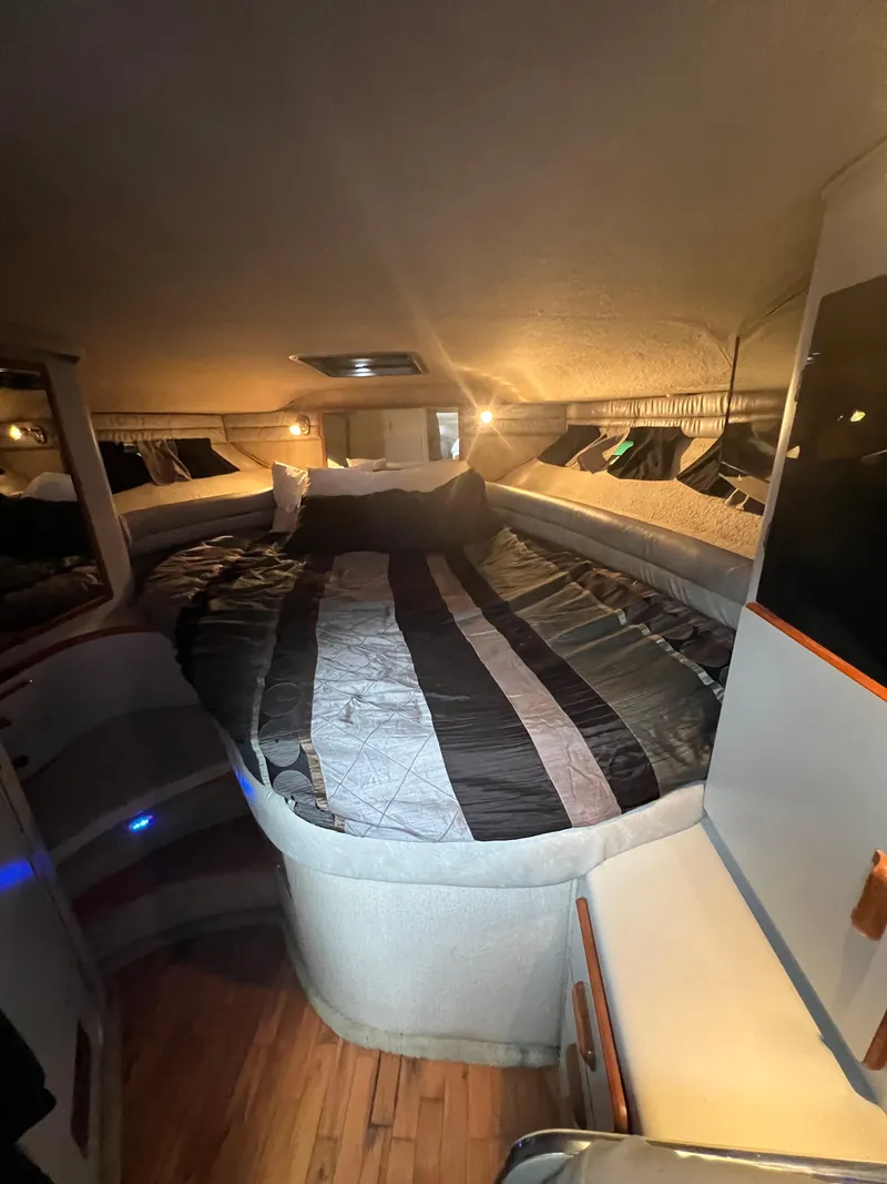 Slide: The Image of Interior cabin of 1991 Sea Ray 350 Sundancer with cozy bed and ambient lighting. - 26