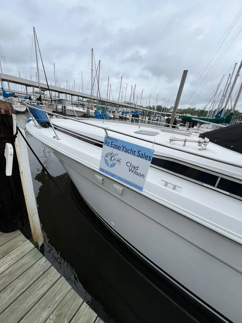 Slide: The Image of 1991 Sea Ray 350 Sundancer yacht docked at marina with sales sign. - 3