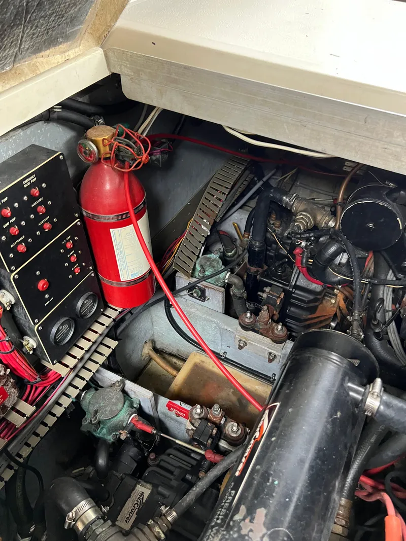 Slide: The Image of Engine room of 1991 Sea Ray 350 Sundancer with fire extinguisher and control panel. - 33