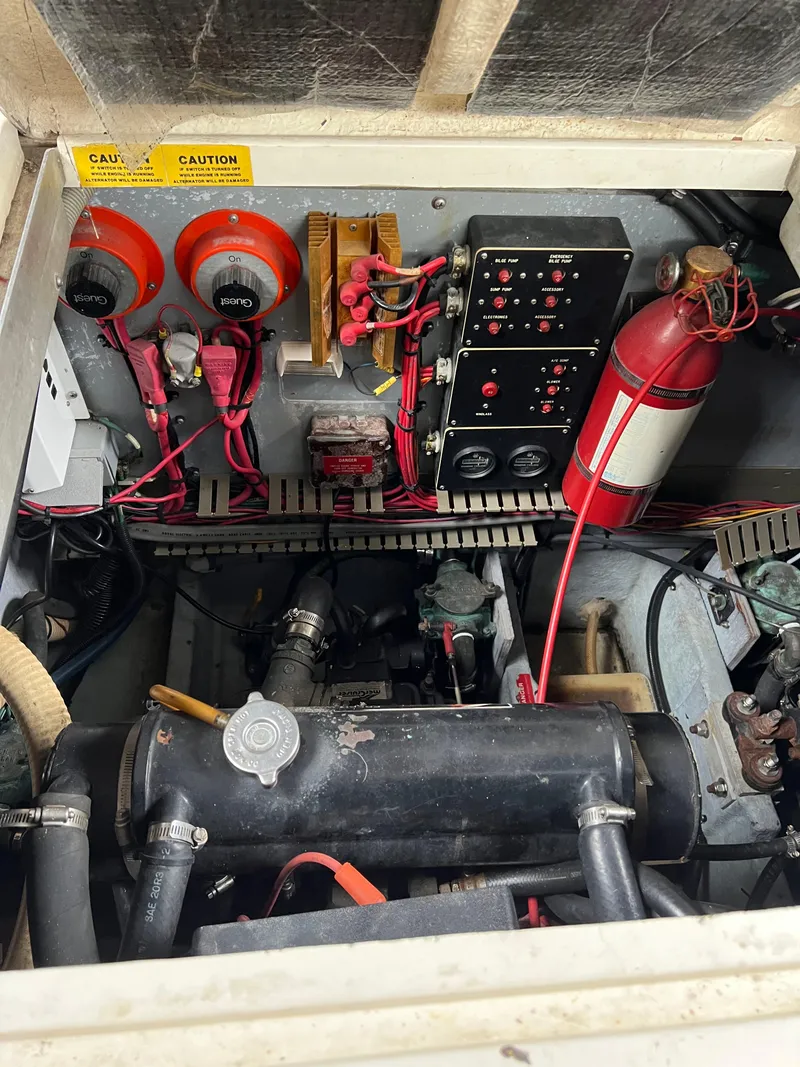 Slide: The Image of Engine compartment of a 1991 Sea Ray 350 Sundancer with visible wiring and fire extinguisher. - 34