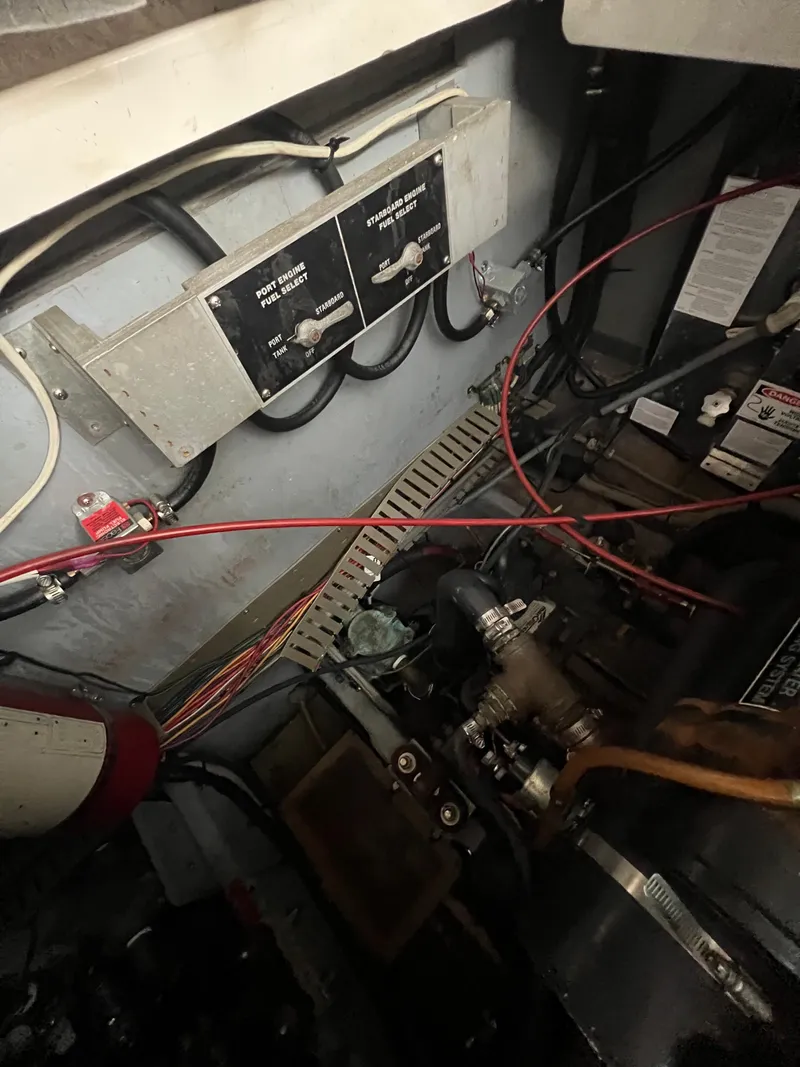 Slide: The Image of Engine compartment of a 1991 Sea Ray 350 Sundancer with visible wiring and control panels. - 35
