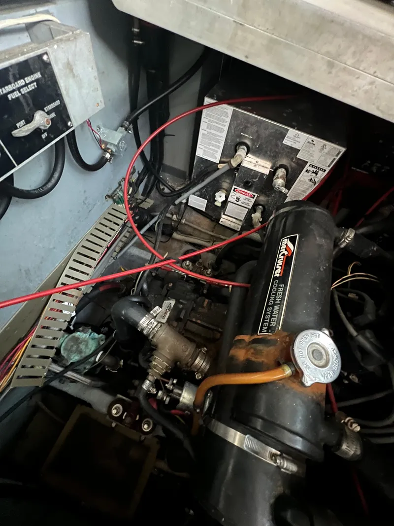 Slide: The Image of Engine compartment of a 1991 Sea Ray 350 Sundancer with visible wiring and components. - 36