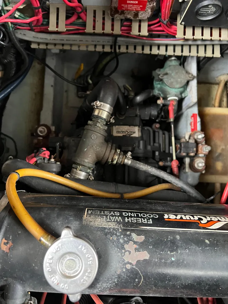 Slide: The Image of Engine compartment of a 1991 Sea Ray 350 Sundancer boat, showing mechanical components and wiring. - 37