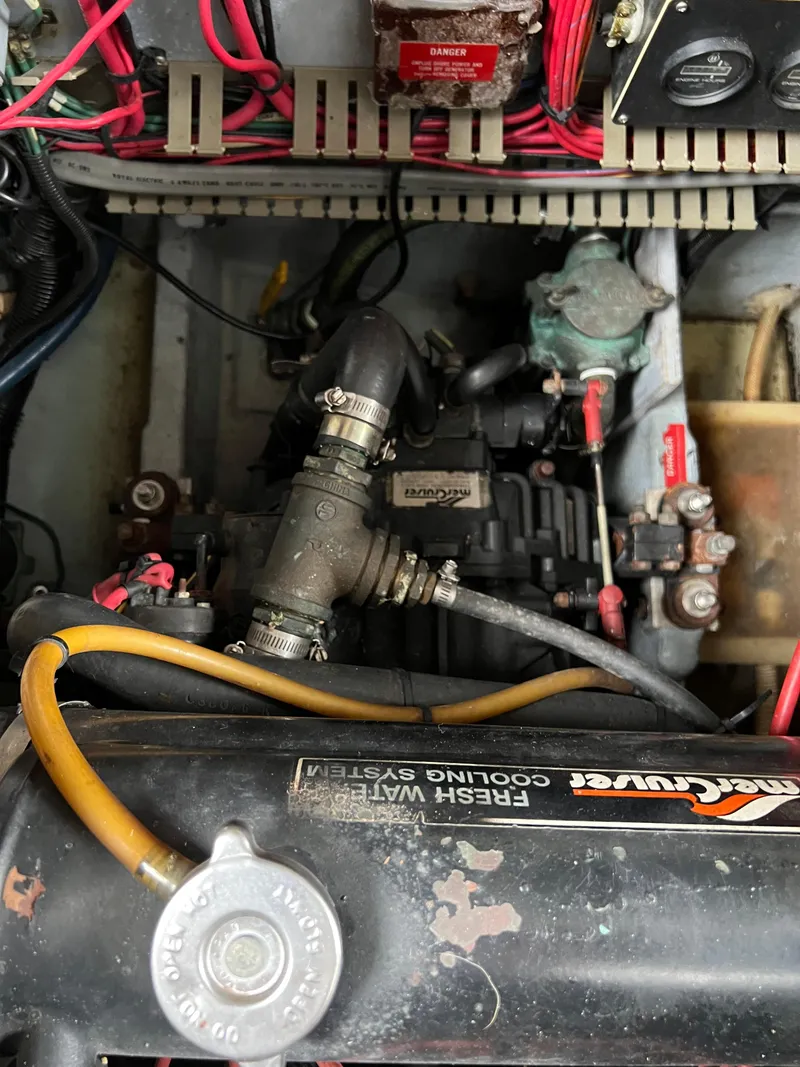 Slide: The Image of Engine compartment of a 1991 Sea Ray 350 Sundancer with visible wiring and components. - 38