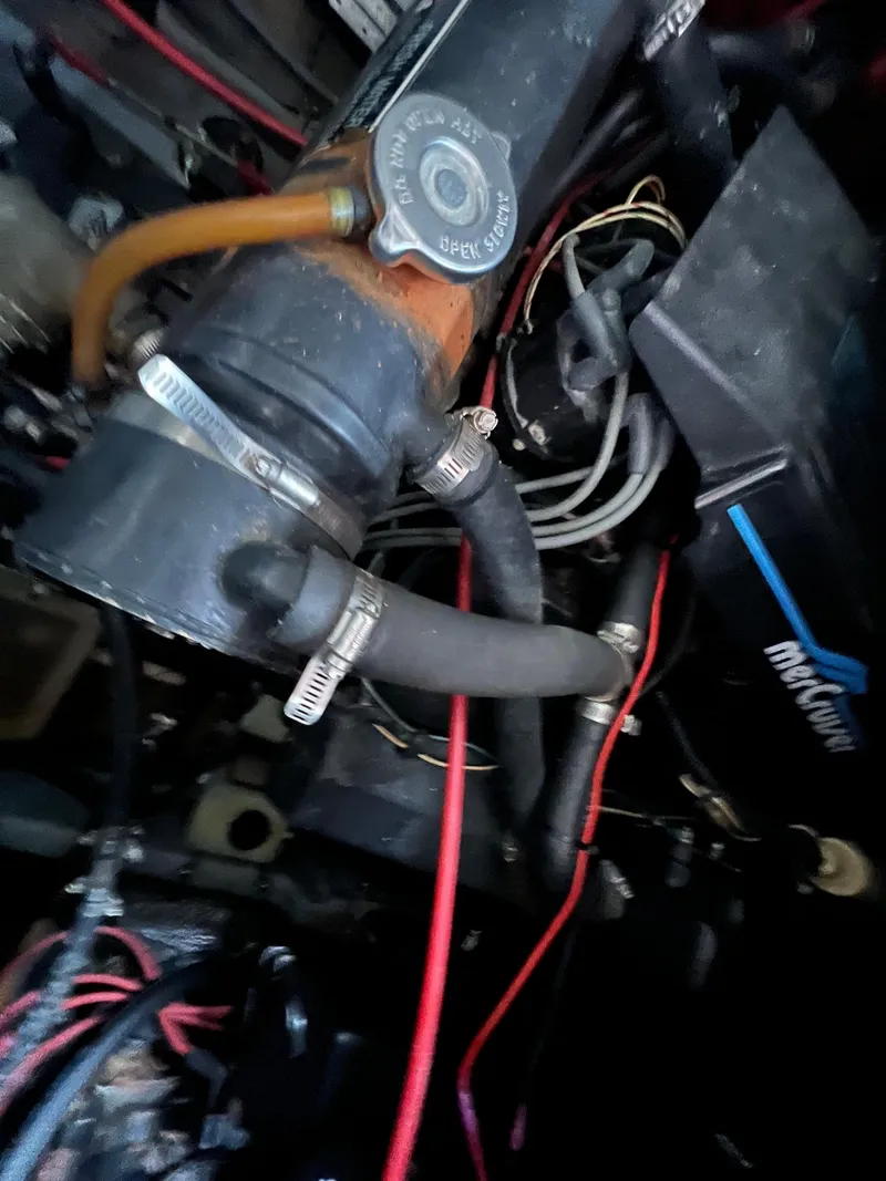 Slide: The Image of Engine components of a 1991 Sea Ray 350 Sundancer boat, featuring hoses and wiring. - 39