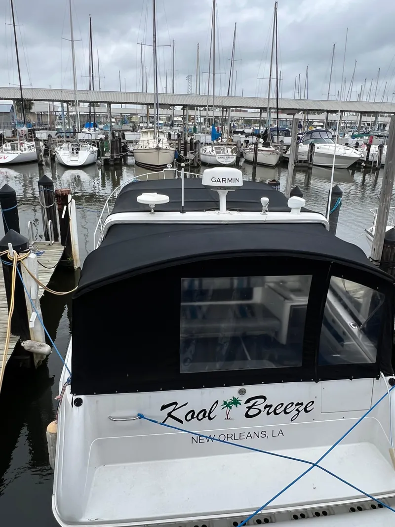 Slide: The Image of 1991 Sea Ray 350 Sundancer docked in marina, New Orleans, LA, with overcast sky. - 4