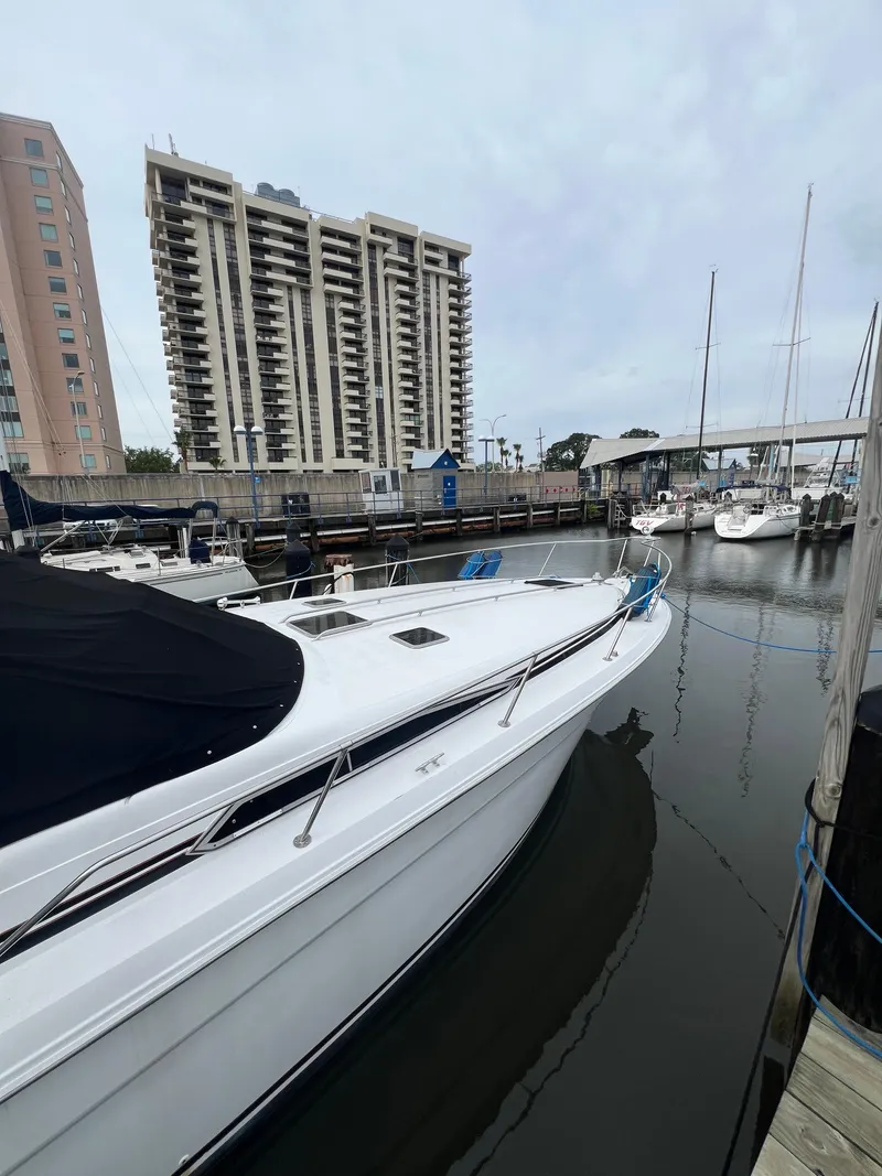 Slide: The Image of 1991 Sea Ray 350 Sundancer docked in marina, with city buildings in background. - 5