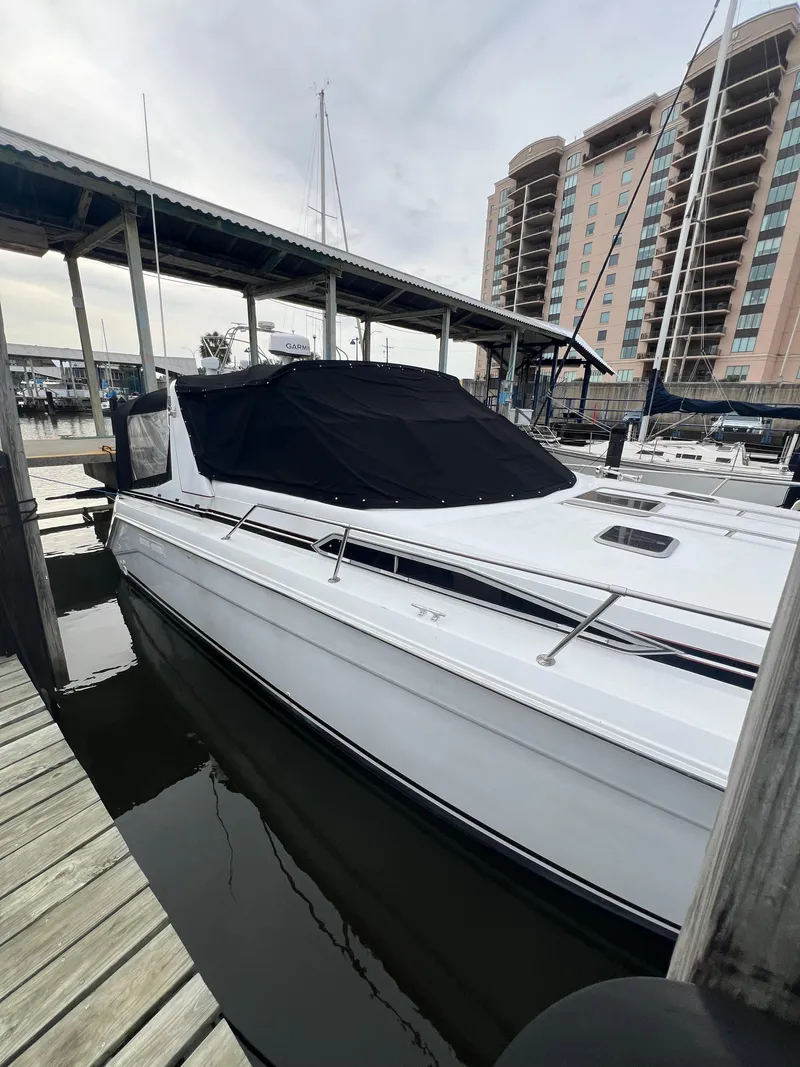 Slide: The Image of 1991 Sea Ray 350 Sundancer docked at marina with covered cabin. - 6