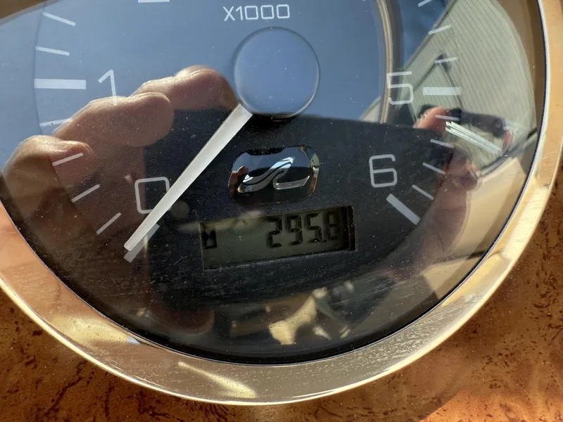 Slide: The Image of Close-up of a 2001 Sea Ray 210 SD tachometer displaying 295.8 hours. - 11