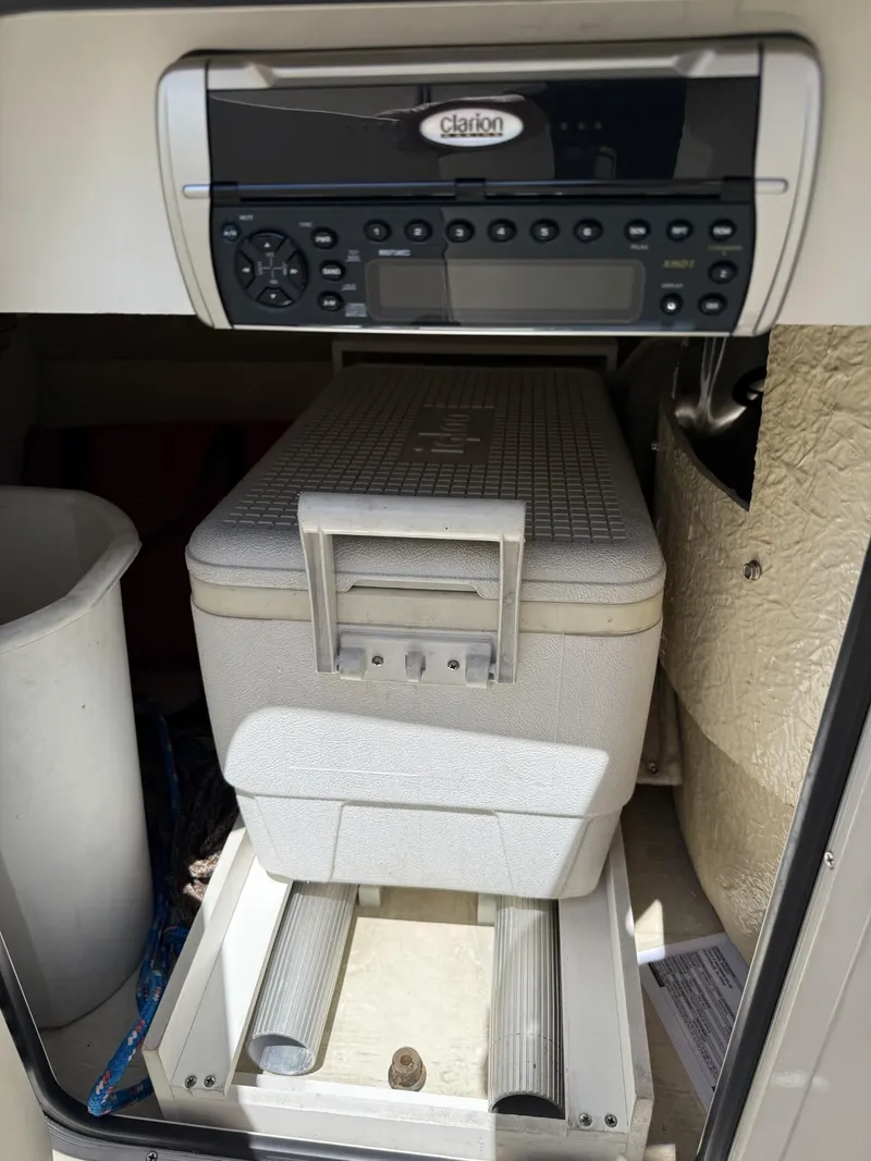 Slide: The Image of 2001 Sea Ray 210 SD boat interior with Clarion stereo and cooler storage compartment. - 12