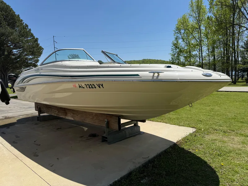 Slide: The Image of 2001 Sea Ray 210 SD boat on a stand, outdoors on a sunny day. - 3