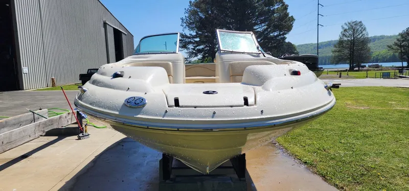 Slide: The Image of 2001 Sea Ray 210 SD boat on display outdoors near a lake and trees. - 5
