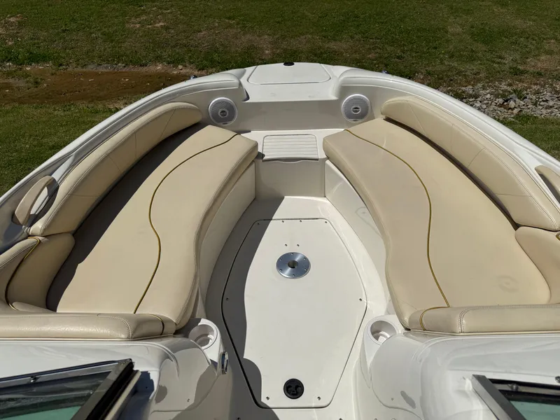 Slide: The Image of 2001 Sea Ray 210 SD boat interior with beige seating and spacious layout. - 6