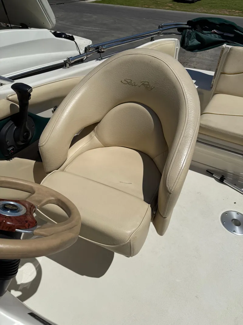 Slide: The Image of Beige captain's chair and steering wheel on 2001 Sea Ray 210 SD boat. - 7