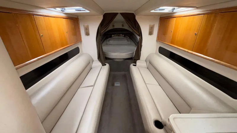 Slide: The Image of Interior of 2002 Black Thunder 460 EC boat with leather seating and wood cabinets. - 10
