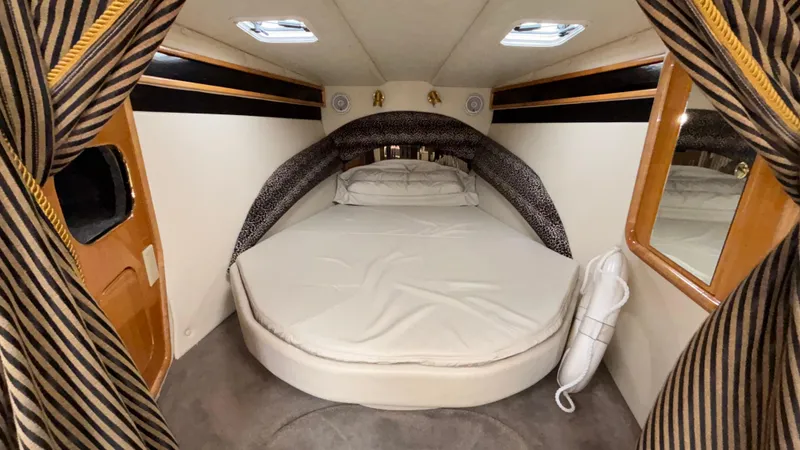 Slide: The Image of Luxurious cabin interior of 2002 Black Thunder 460 EC boat with round bed and elegant decor. - 11