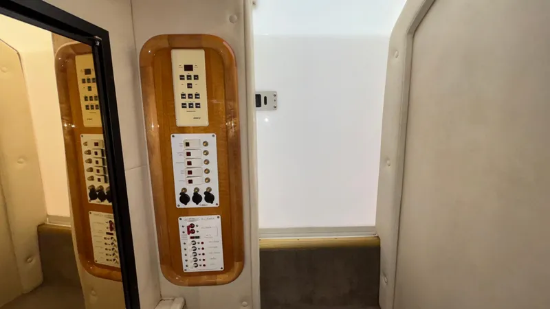 Slide: The Image of Control panel inside 2002 Black Thunder 460 EC boat cabin, featuring switches and dials. - 15