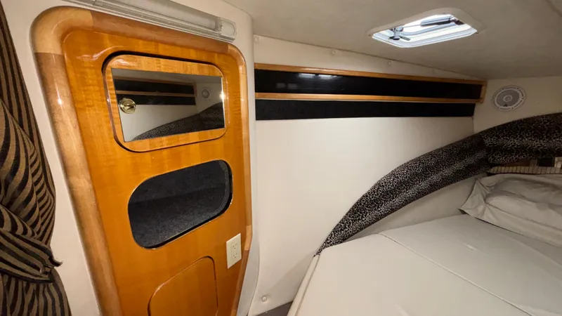 Slide: The Image of Interior cabin of 2002 Black Thunder 460 EC boat with wooden door and bed. - 17