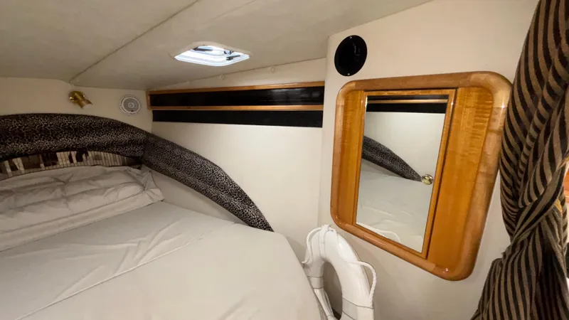 Slide: The Image of 2002 Black Thunder 460 EC cabin interior with bed, mirror, and porthole. - 18