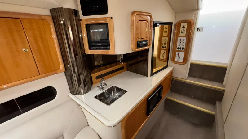 Slide: The Image of Luxurious 2002 Black Thunder 460 EC yacht interior with kitchenette and modern amenities. - 19