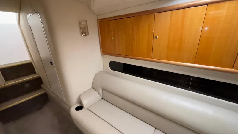 Slide: The Image of Interior of 2002 Black Thunder 460 EC boat with beige seating and wooden cabinets. - 20