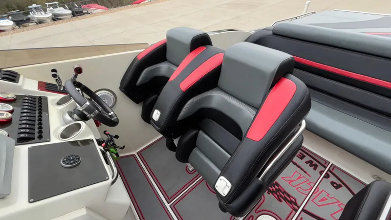 Slide: The Image of Interior of 2002 Black Thunder 460 EC boat with black and red seating. - 21