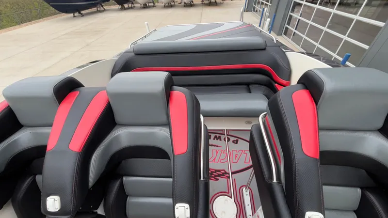 Slide: The Image of Interior of 2002 Black Thunder 460 EC boat with red and gray seating. - 22