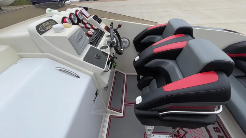 Slide: The Image of 2002 Black Thunder 460 EC cockpit with dual black and red seats, steering wheel, and control panel. - 24