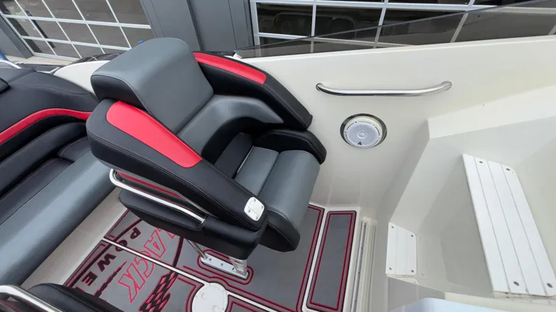 Slide: The Image of Luxury seating on 2002 Black Thunder 460 EC boat, featuring sleek black and red design. - 25