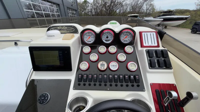 Slide: The Image of Dashboard of a 2002 Black Thunder 460 EC boat with gauges and controls. - 27