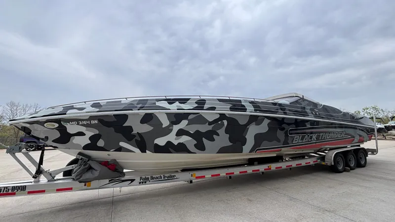 Slide: The Image of 2002 Black Thunder 460 EC powerboat with camouflage design on a trailer. - 3