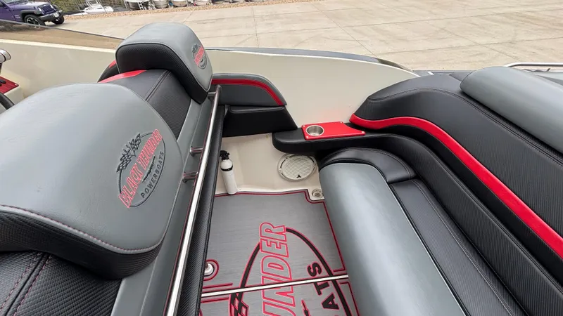 Slide: The Image of 2002 Black Thunder 460 EC boat interior with gray and red seating and logo detailing. - 33