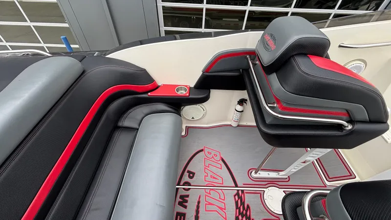 Slide: The Image of Interior of 2002 Black Thunder 460 EC boat with black and red seating. - 34