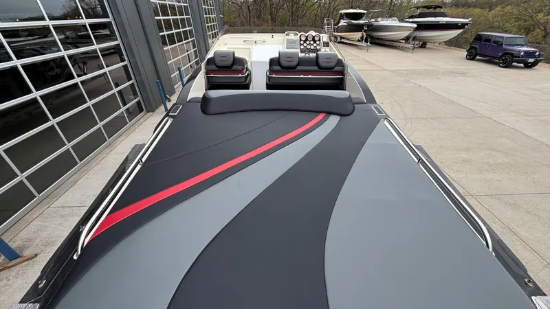 Slide: The Image of 2002 Black Thunder 460 EC boat with sleek design and red accents, docked near other boats. - 37