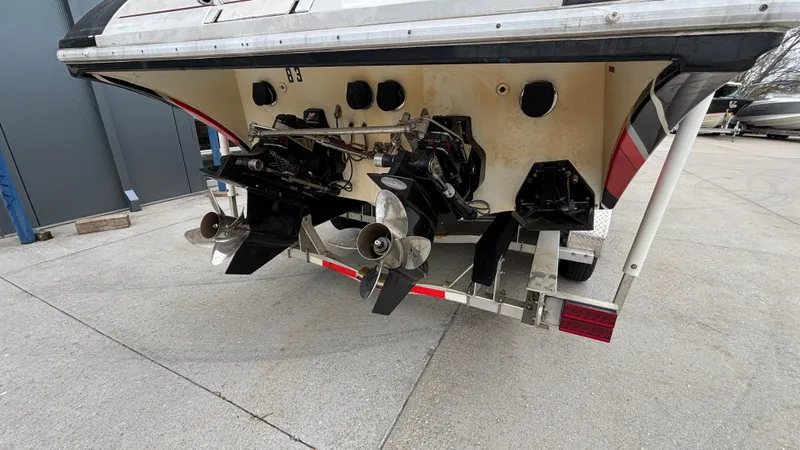 Slide: The Image of Rear view of a 2002 Black Thunder 460 EC boat showing dual propellers and outboard motors. - 42