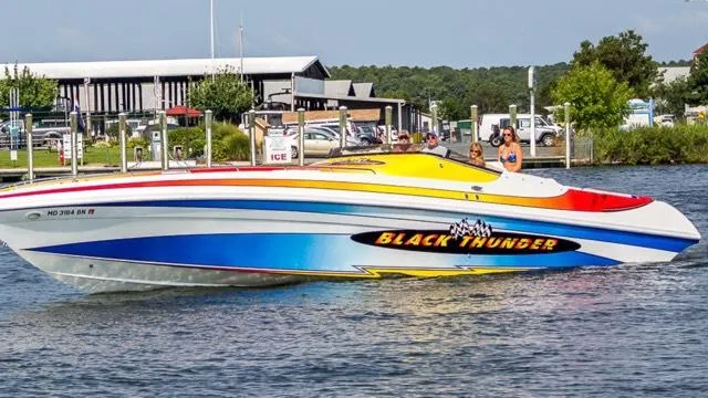 Slide: The Image of 2002 Black Thunder 460 EC speedboat with vibrant colors cruising on a sunny day. - 44