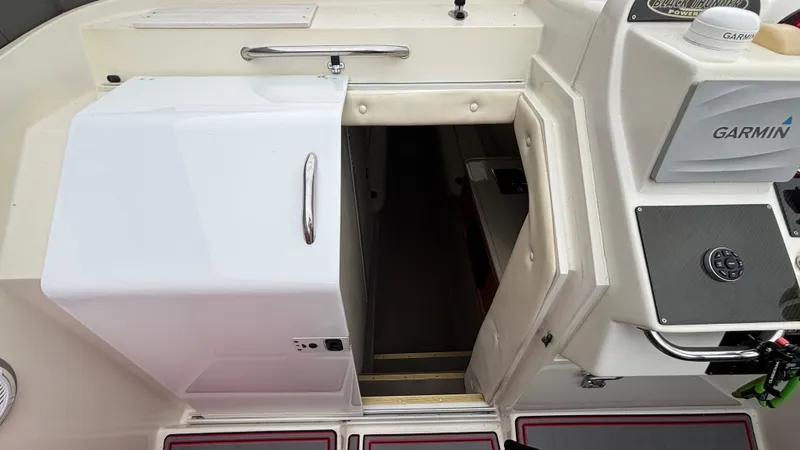 Slide: The Image of 2002 Black Thunder 460 EC boat interior with Garmin navigation system and cabin entrance. - 6