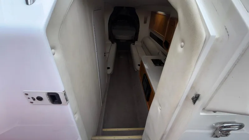 Slide: The Image of Interior view of 2002 Black Thunder 460 EC boat, featuring seating and kitchenette. - 7