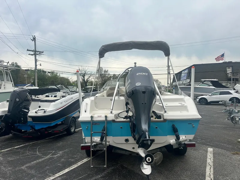 Slide: The Image of 2023 Key West 203 DFS boat with outboard motor in a parking lot. - 10